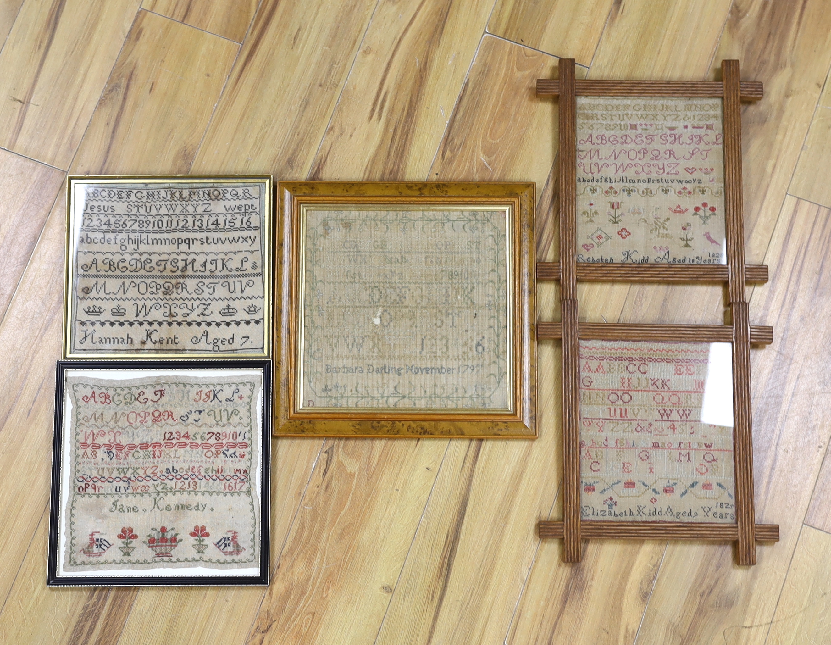 A George III dated 1797 framed alphabet sampler, by Barbara Darling and two similar dated samplers 1825 and 1828 by Elizabeth Kidd, together with a later undated 19th century sampler by Jane Kennedy (4)